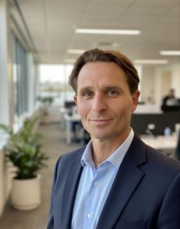 Profile picture of a man in an office setting